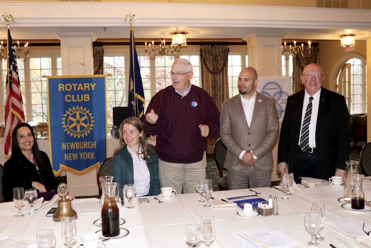 Dr. Padilla stands with members of the Rotary Club during initiation