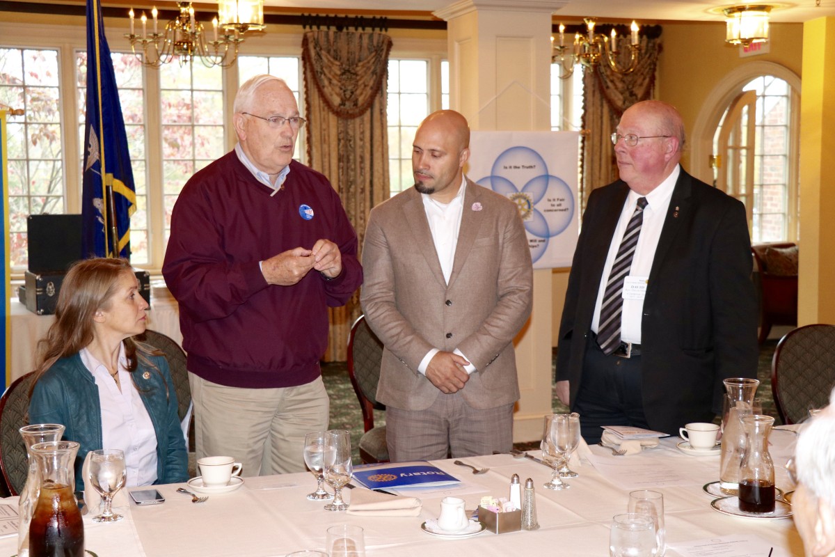 Dr. Padilla stands with members of the Rotary Club during initiation