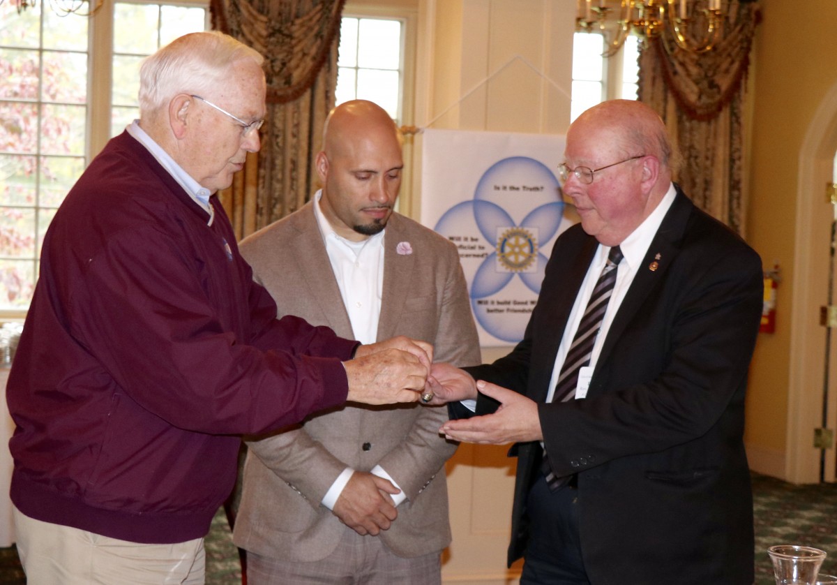 Dr. Padilla stands with members of the Rotary Club during initiation