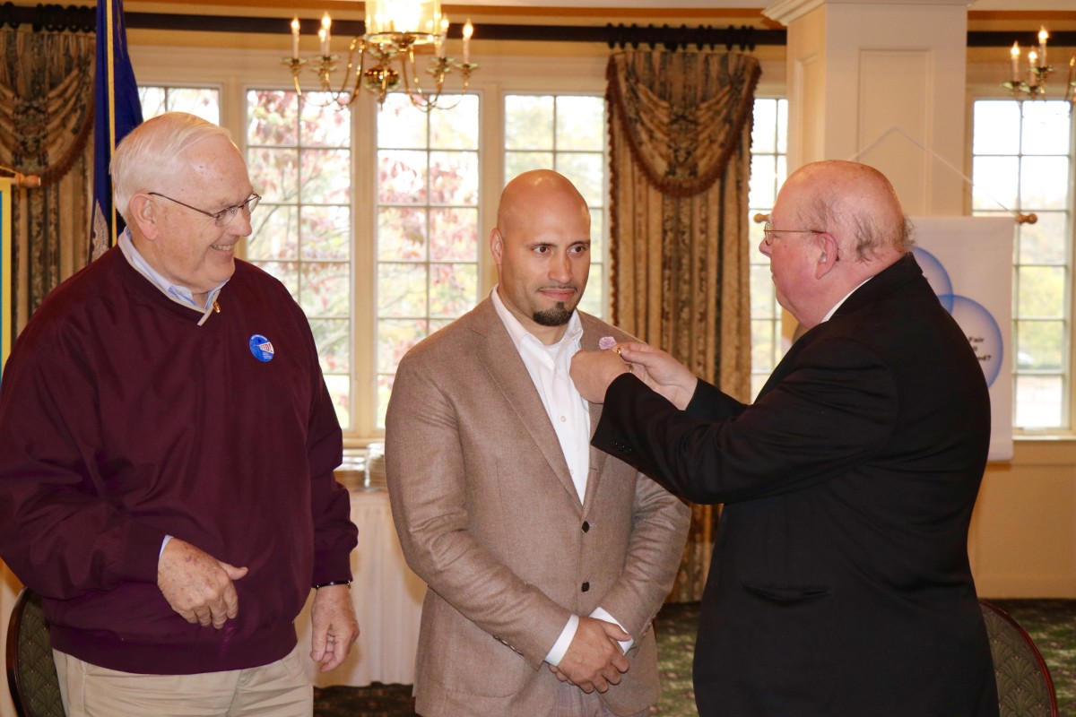 Dr. Padilla stands with members of the Rotary Club during initiation