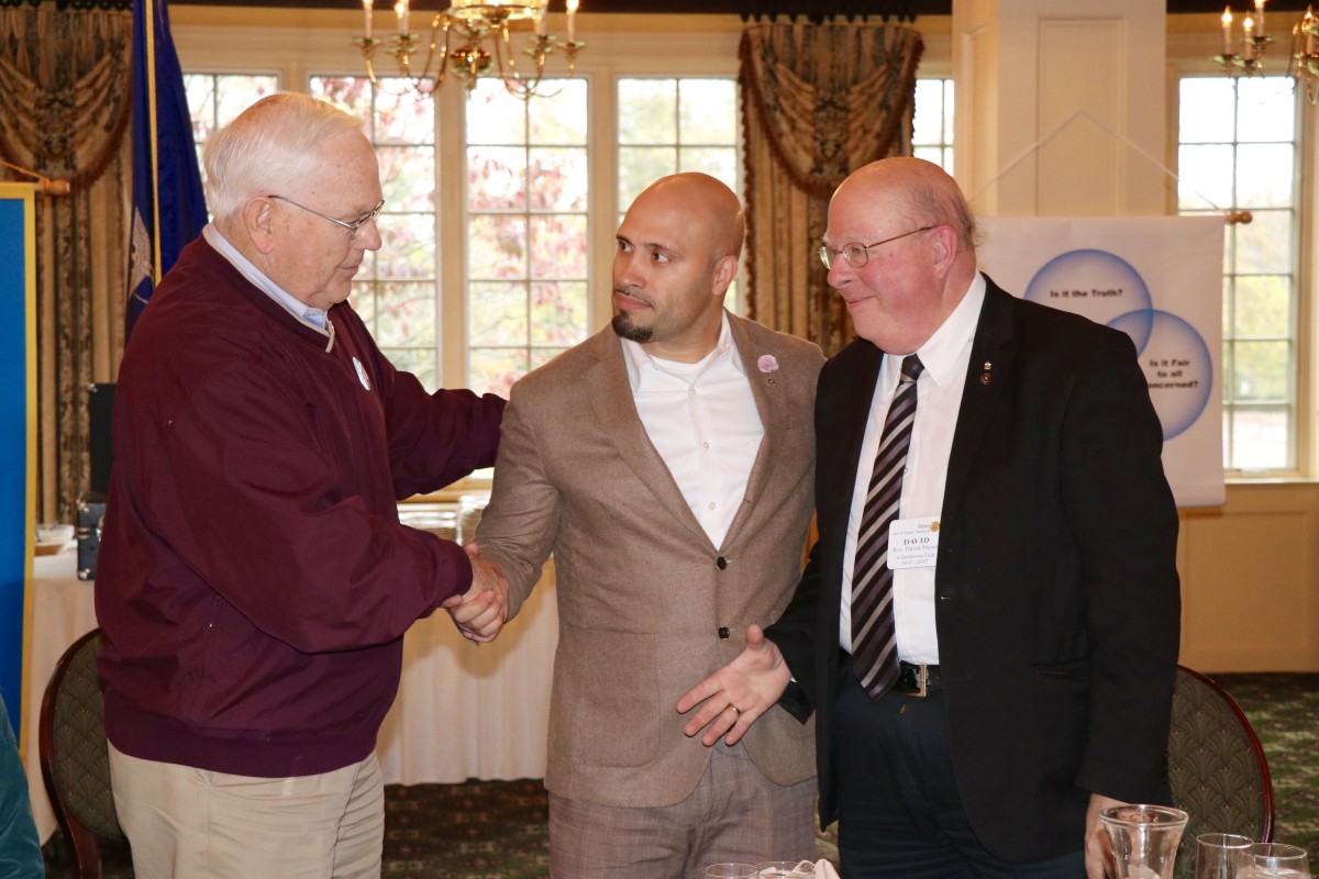 Dr. Padilla stands with members of the Rotary Club during initiation