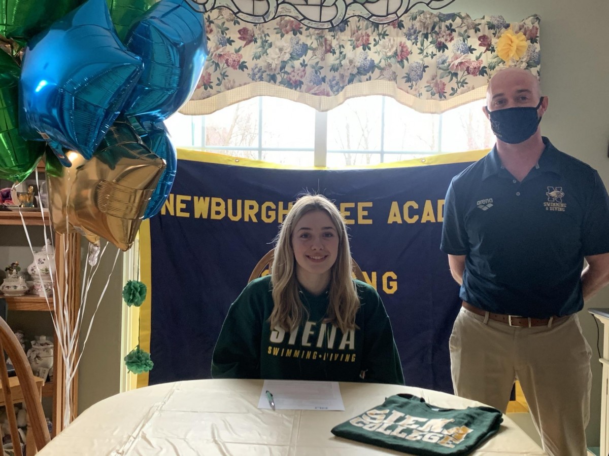 Shaylea Triller poses for a photo with swimming coach, Coach Pat Kavanaugh.