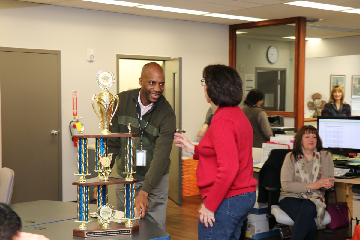 The trophy is handed to a representative from the department.