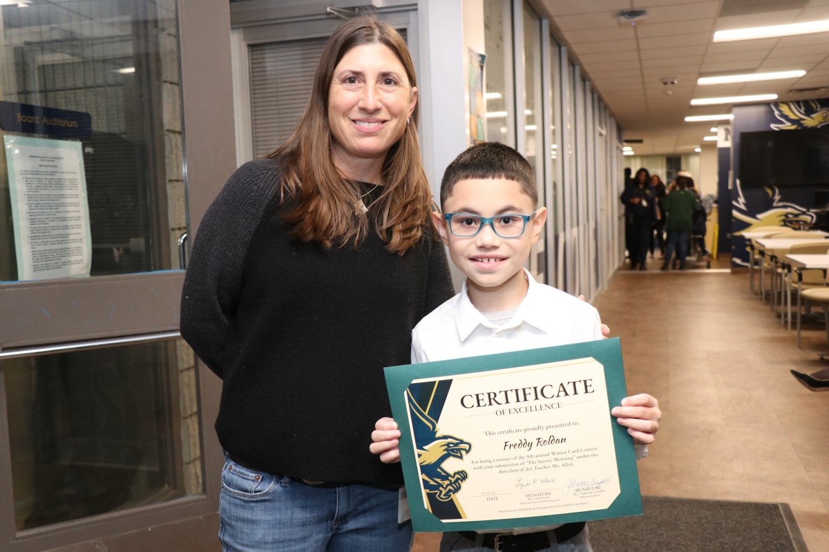 Freddy Roldan poses for a photo with with his art teacher, Ms. Kayla Allen.
