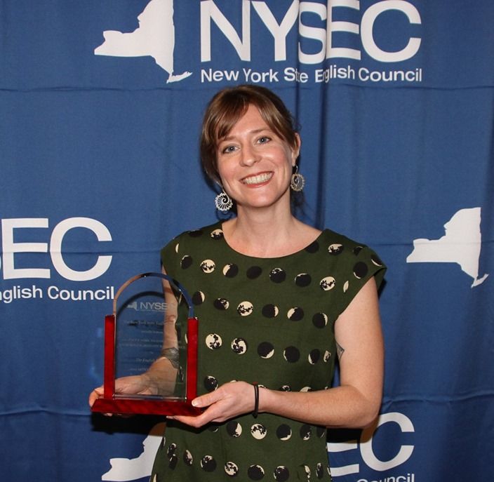 NFA North teacher, Ms. Jackie Hesse poses for a photo while holding her award.