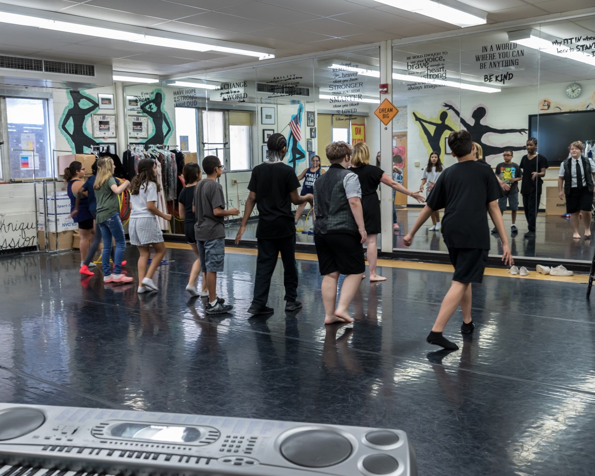 Students prepare in dance studio.