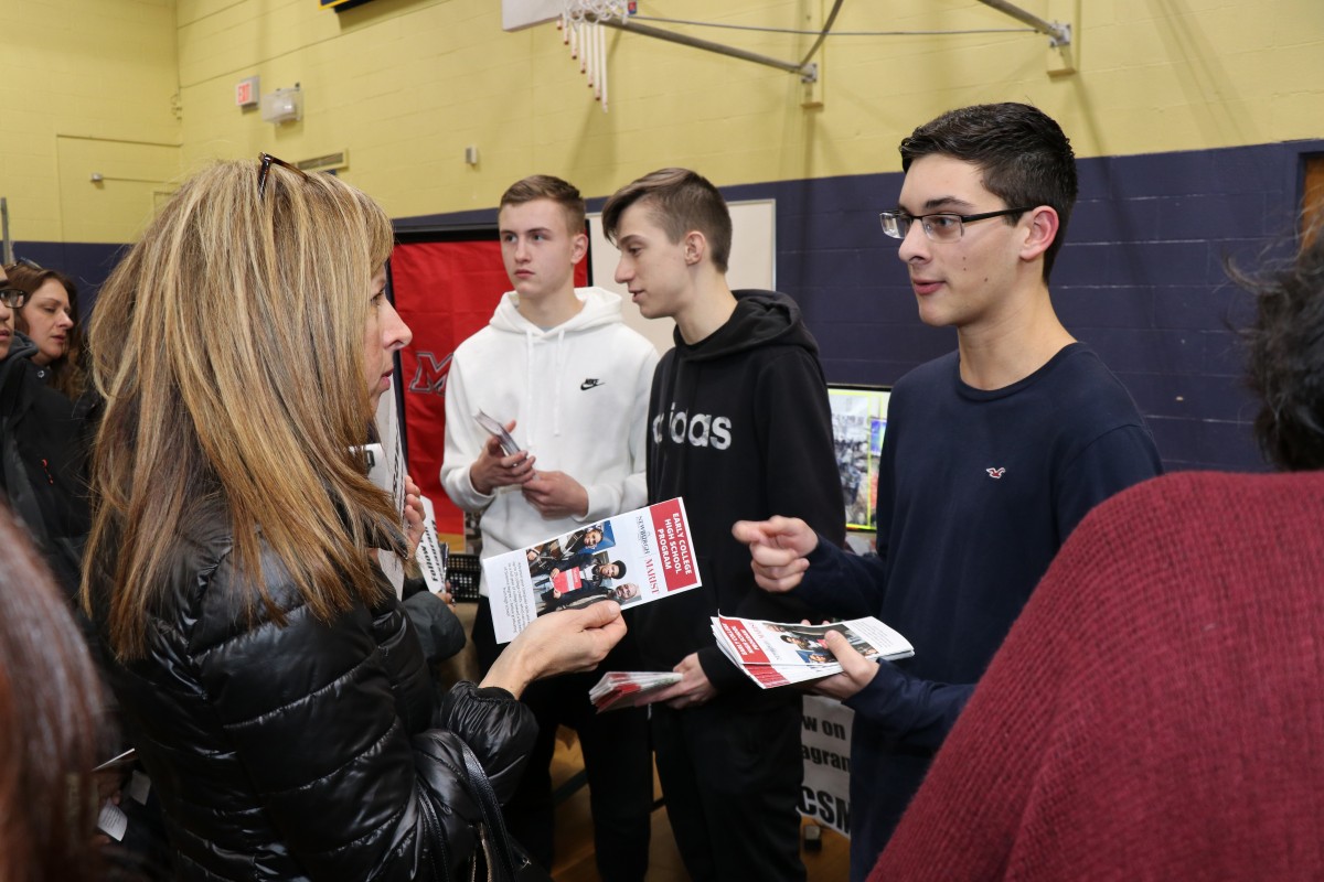 Students talk to students and their families about the program.