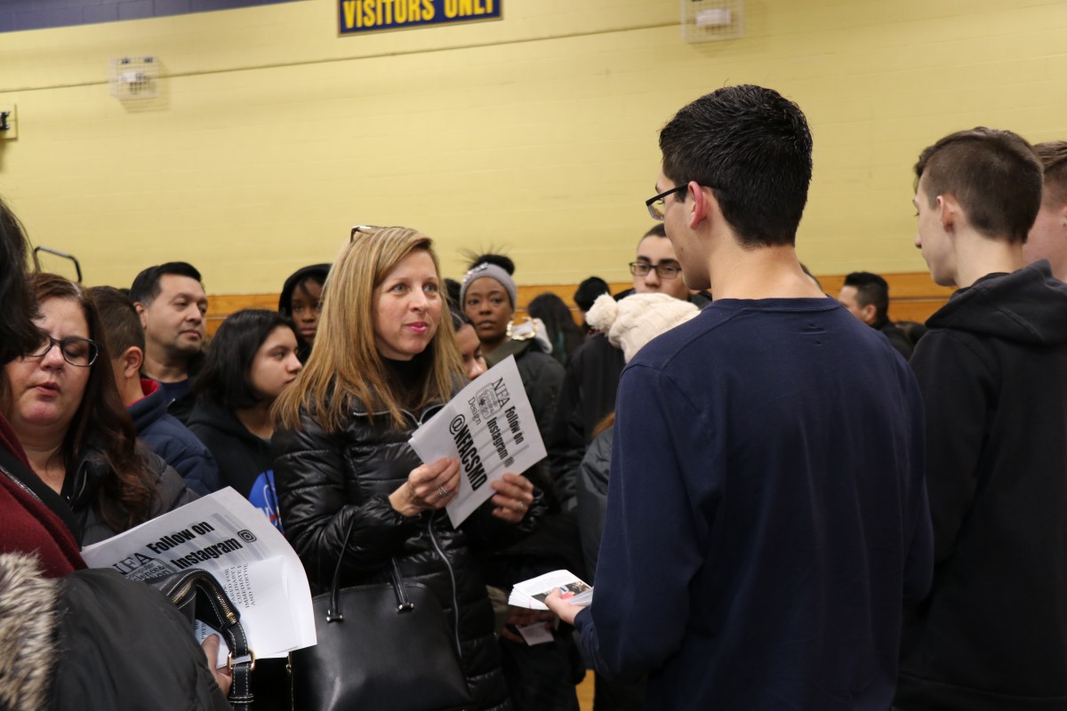 Students talk to students and their families about the program.