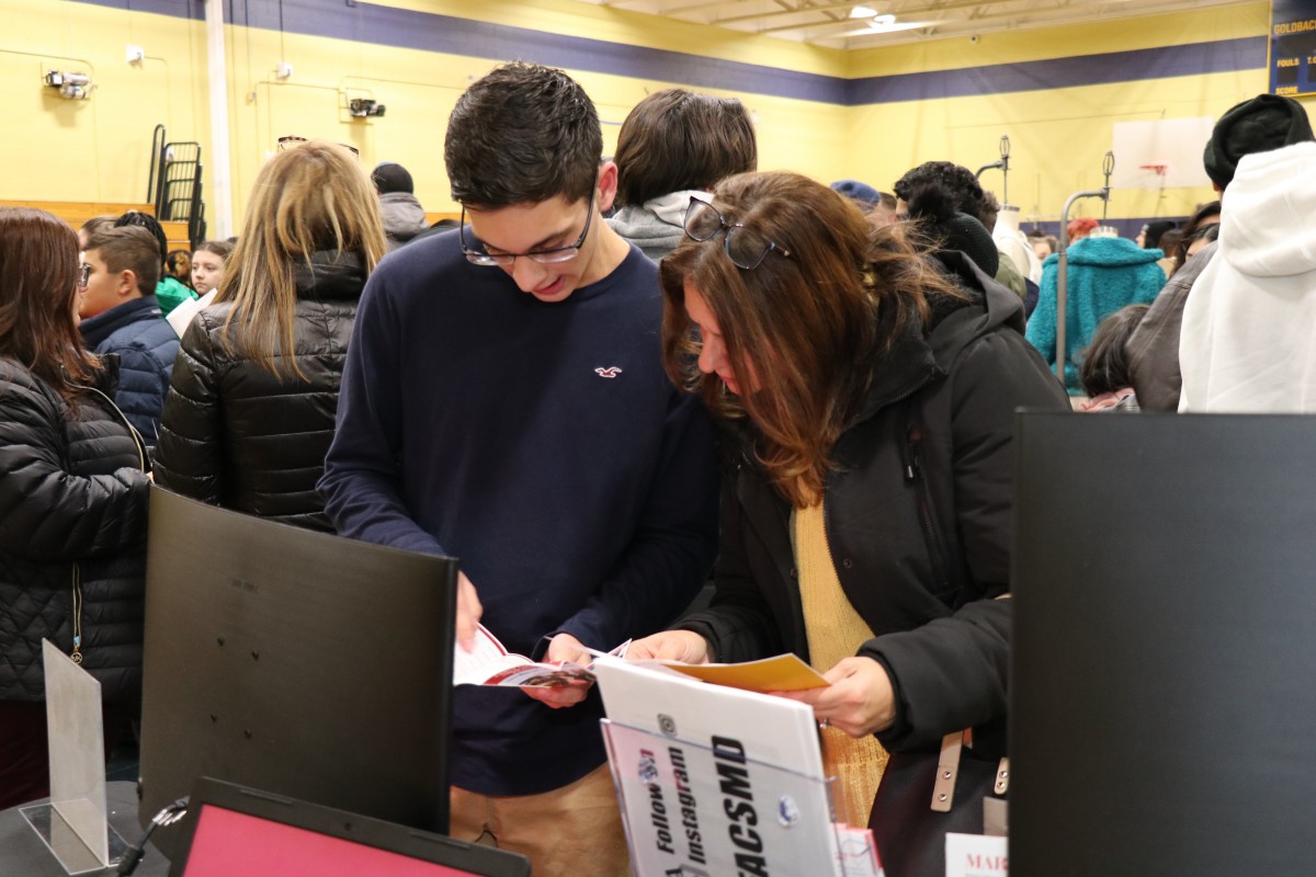 Students talk to students and their families about the program.