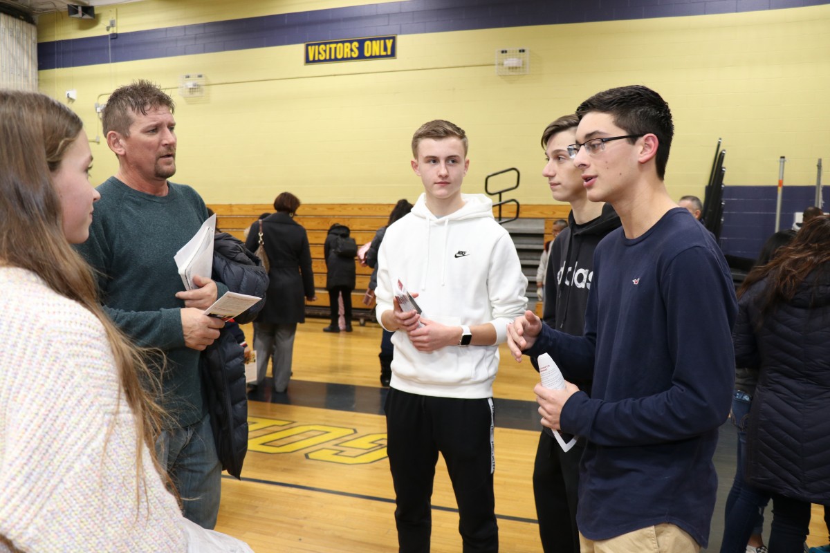 Students talk to students and their families about the program.