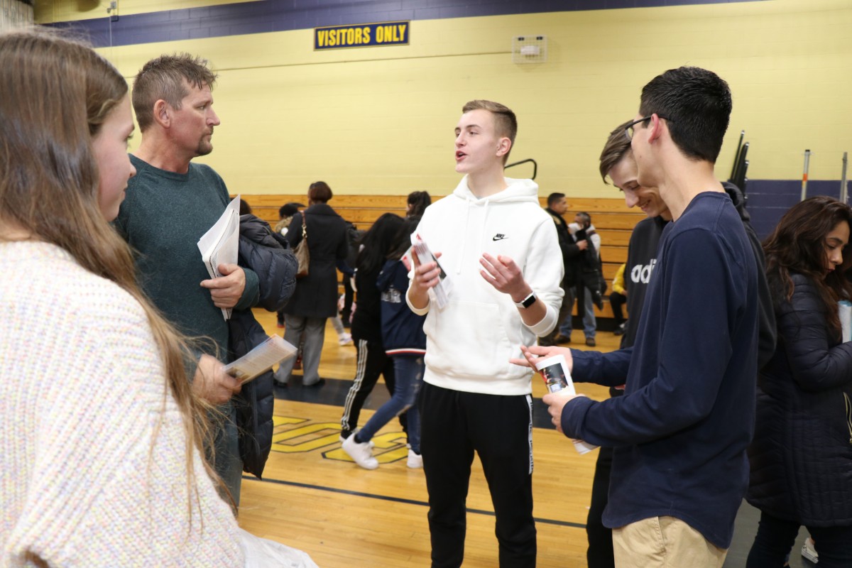 Students talk to students and their families about the program.