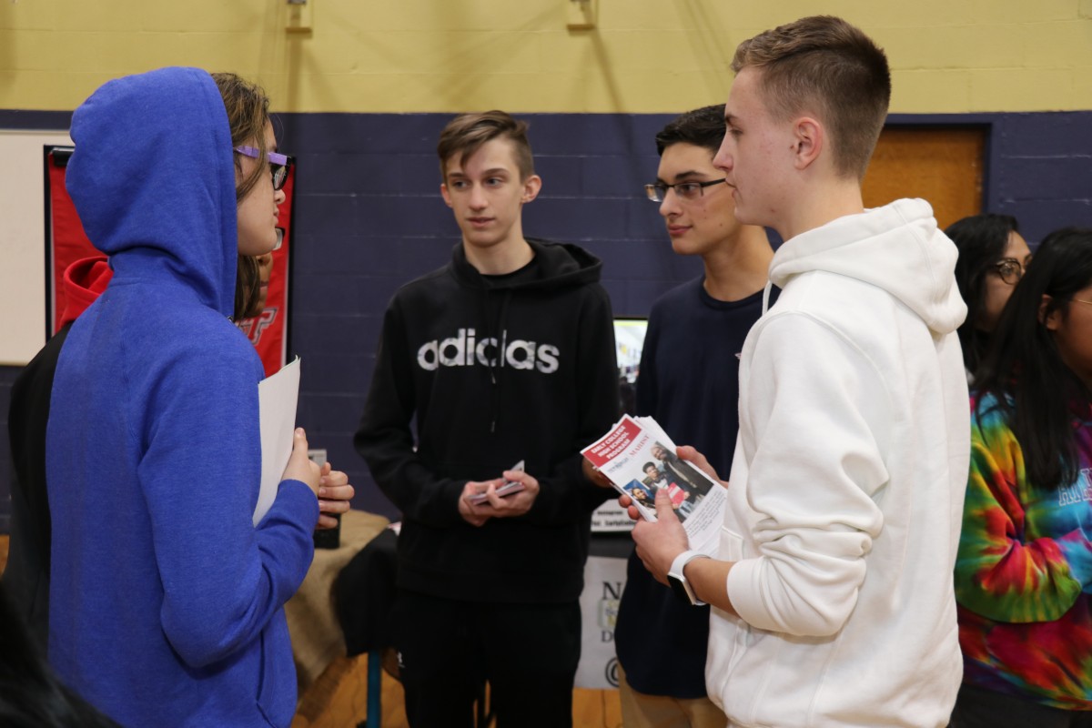 Students talk to students and their families about the program.