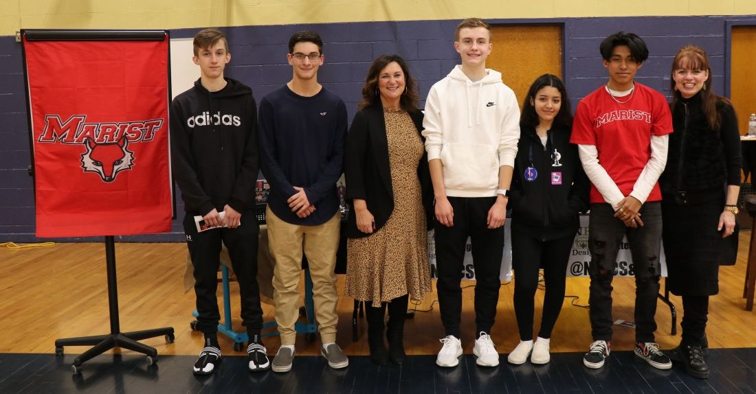 Scholars pose for a  photo with program administrator Ms. Susan Valentino and teacher Ms. Elizabeth Thomas-Cappello