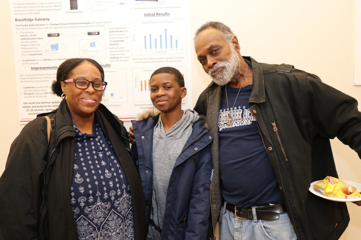 Student and parents pose for a photo.