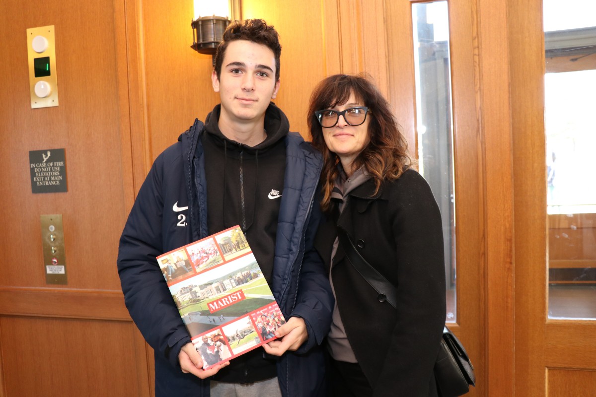 Student and parent pose for photo.