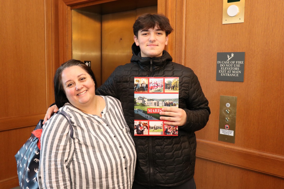 Student and parent pose for photo.