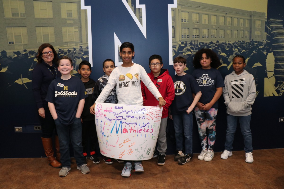 Scholars pose for a photo with their team.