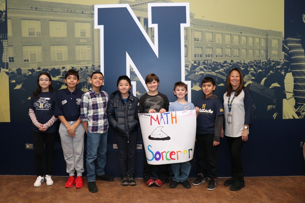 Scholars pose for a photo with their team.