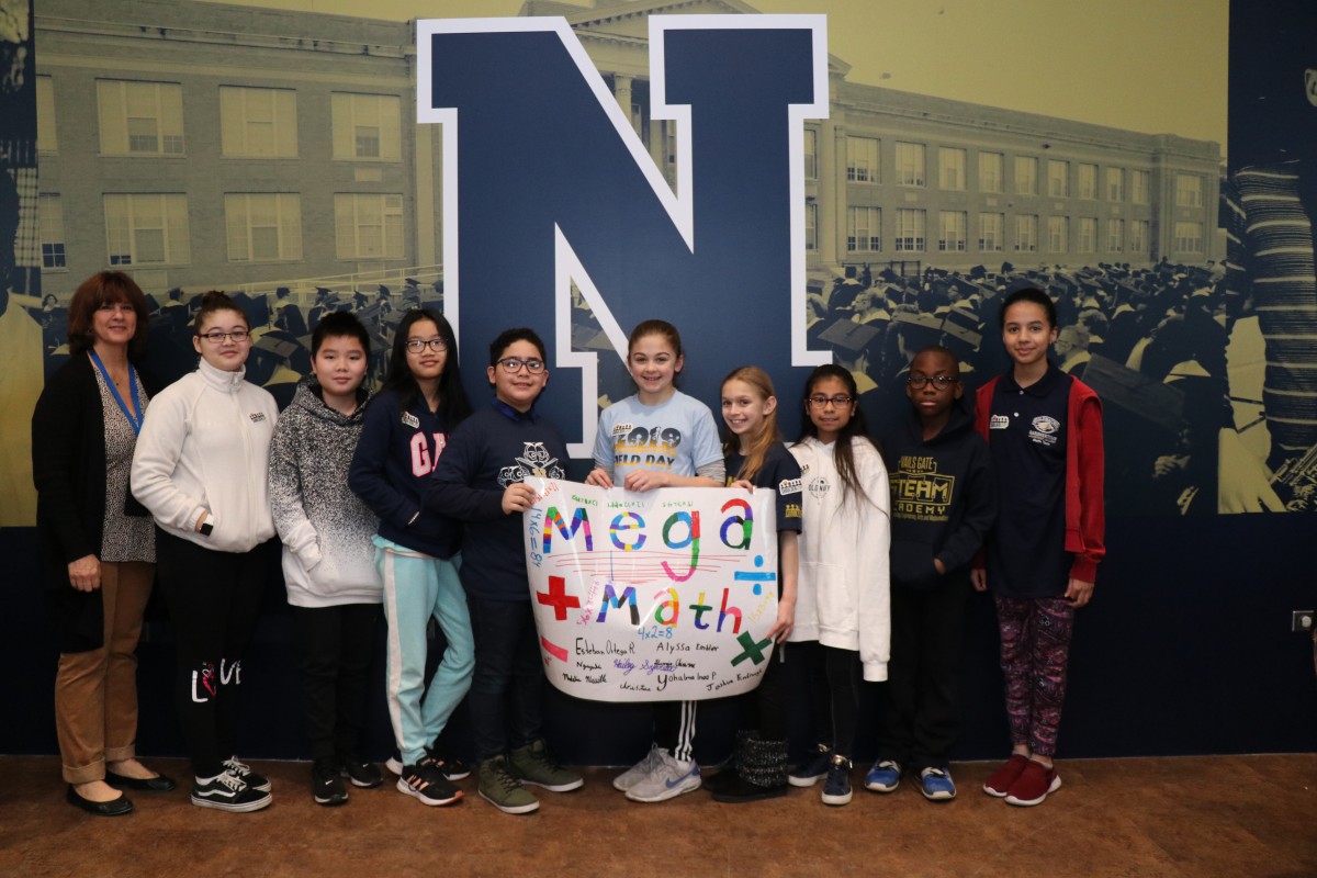 Scholars pose for a photo with their team.