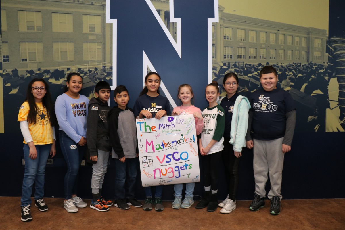 Scholars pose for a photo with their team.