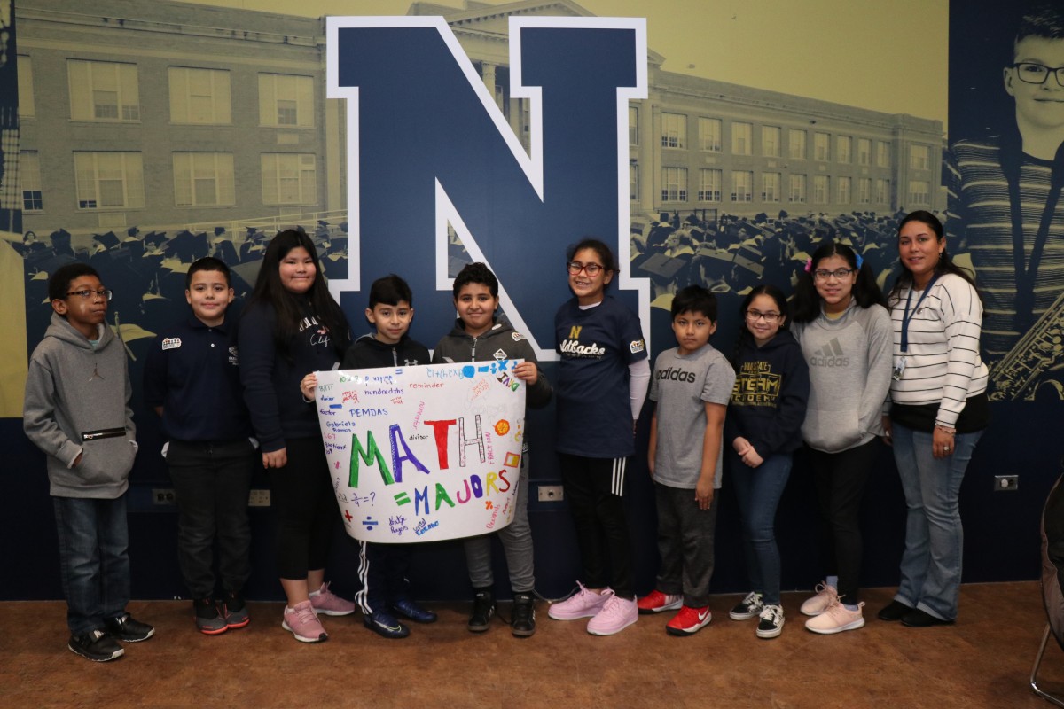 Scholars pose for a photo with their team.