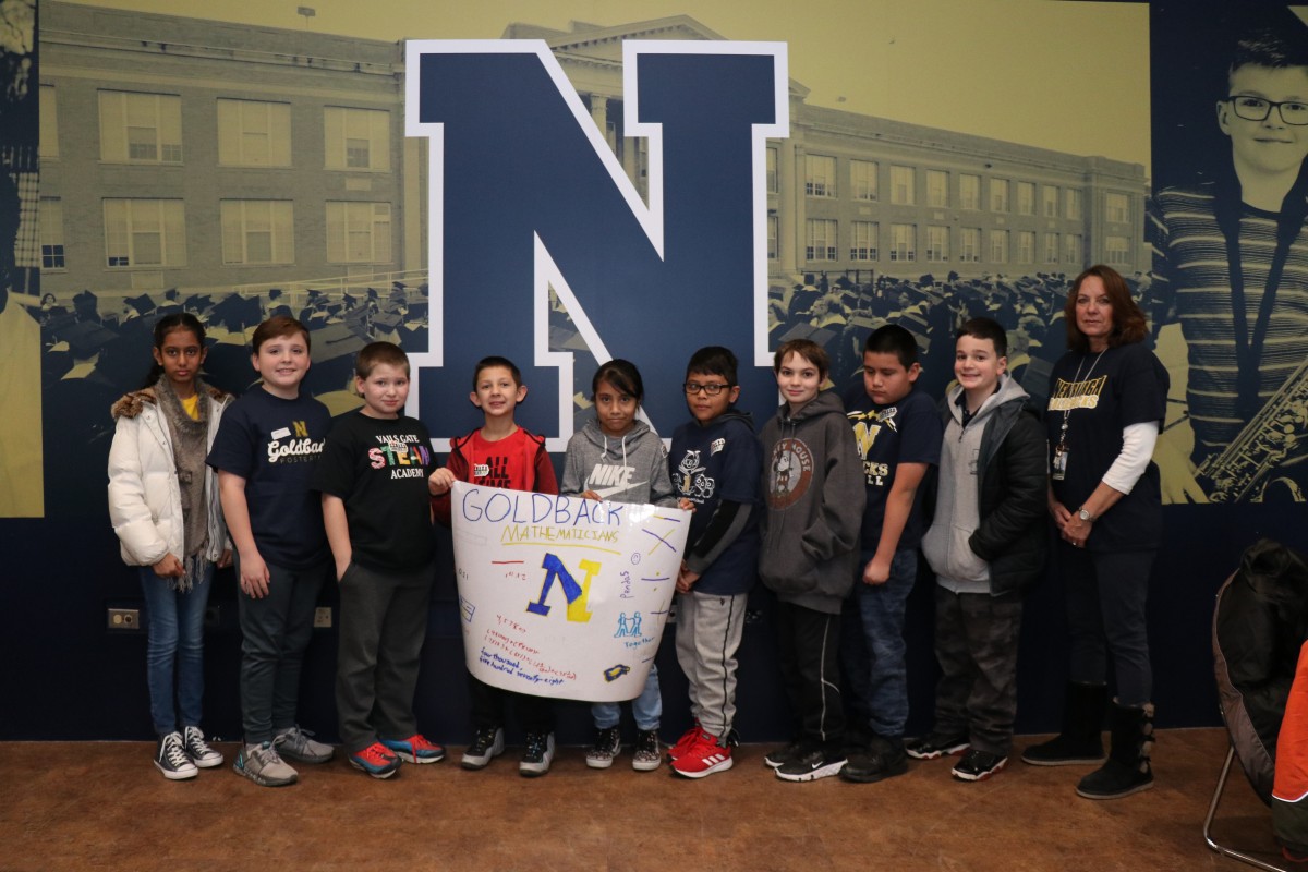 Scholars pose for a photo with their team.