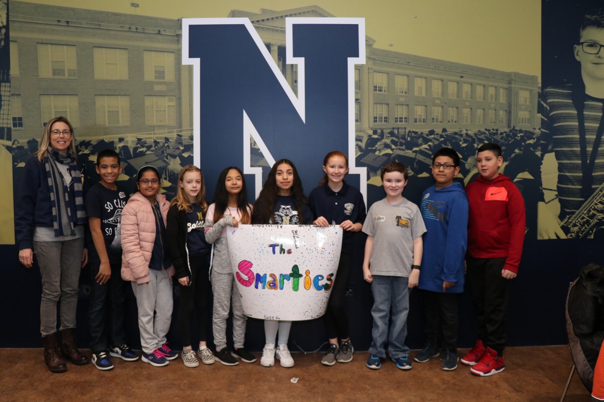 Scholars pose for a photo with their team.