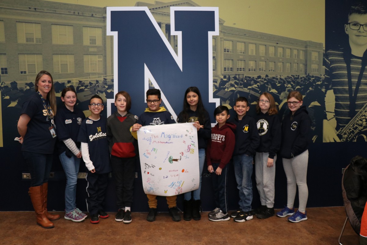 Scholars pose for a photo with their team.