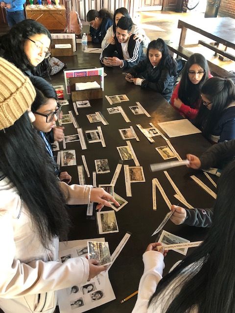 Students look at historic photos.