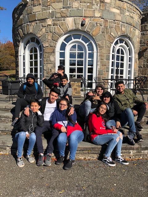 Students pose for photo by Shelter House in Downing Park.