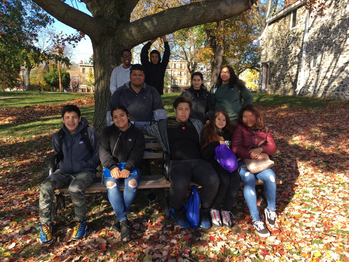 Students pose for photo under tree.