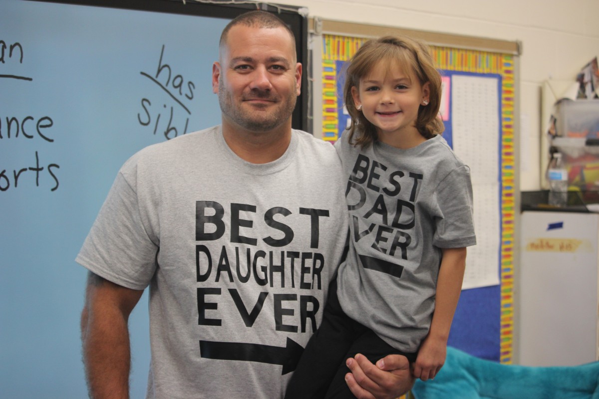 Father and child pose for photo.