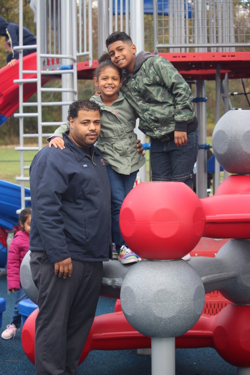 Father and child pose for photo.