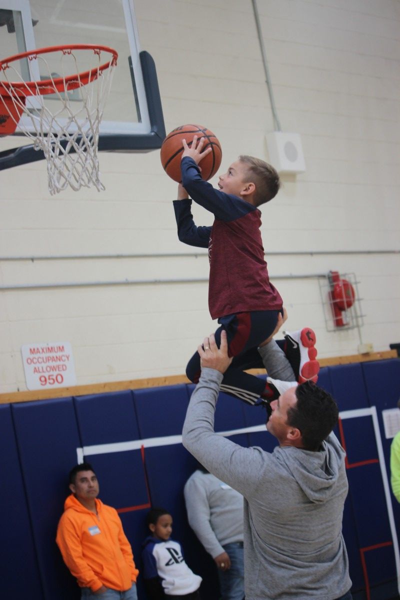 Father helping child make basket.