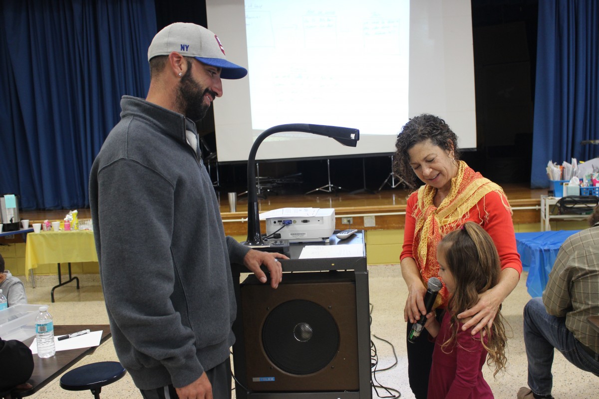 Father and child talking to teacher.