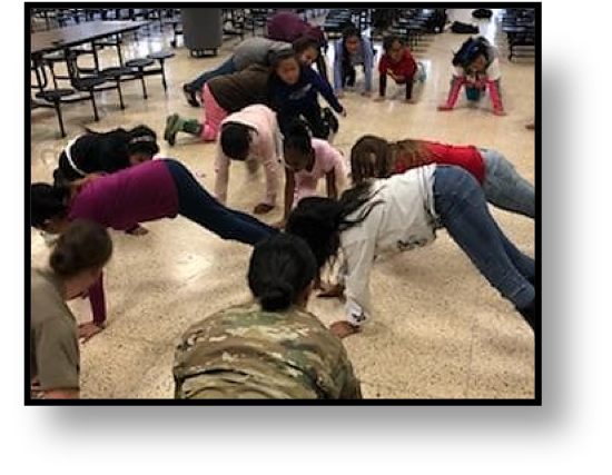 Cadets encourage the girls of their physical ability in the opening activity.