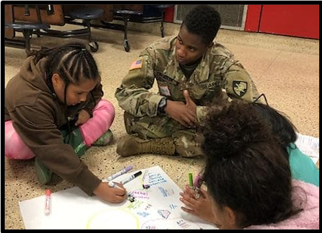 Cadet Alana Chandler directs her group to write down ideas for their goals.