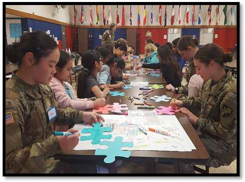 Cadets and the girls of Meadow Hill decorate individual puzzle pieces to take home as a reminder of the lesson.