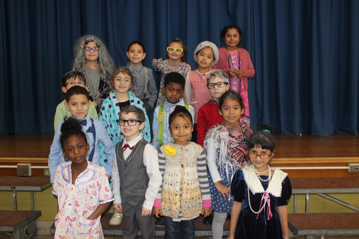 Students pose for a photo wearing costumes of a 100 year old.