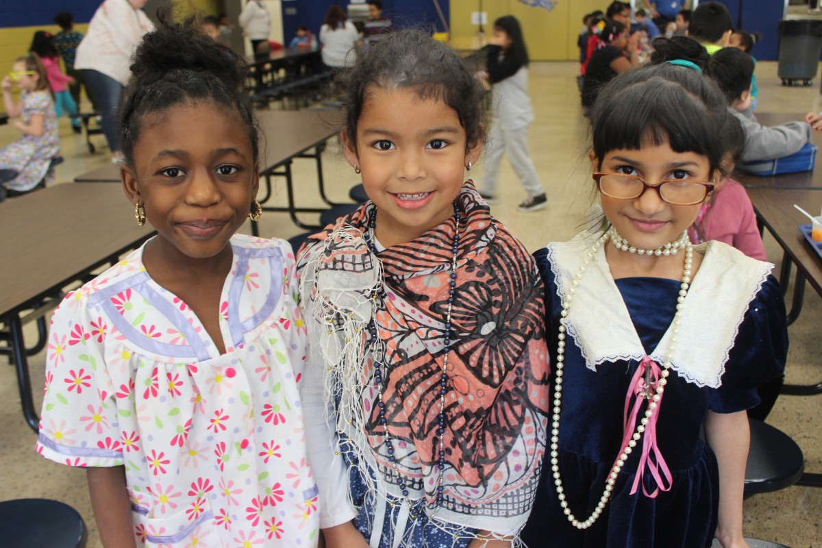 Students pose for a photo wearing costumes of a 100 year old.