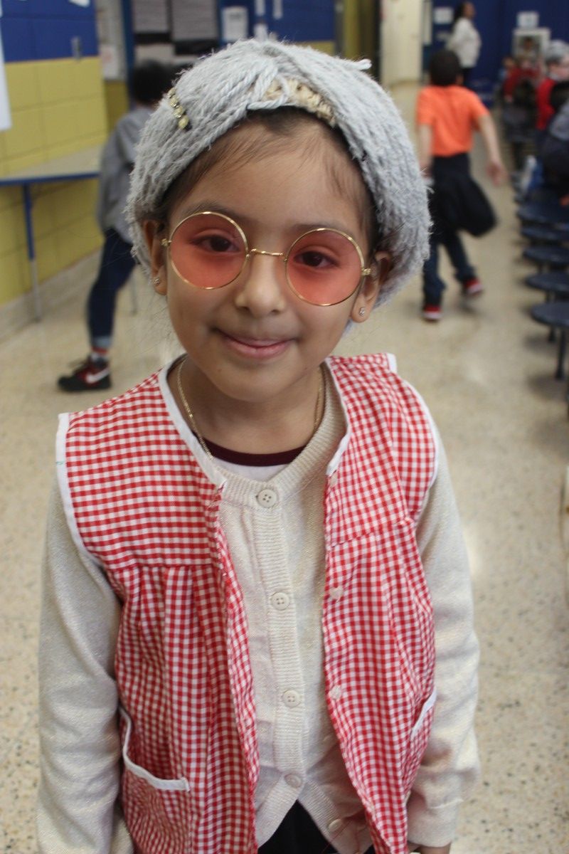 Students pose for a photo wearing costumes of a 100 year old.