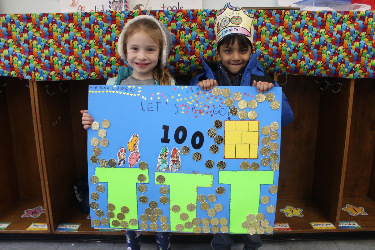 Students pose for a photo wearing costumes of a 100 year old.