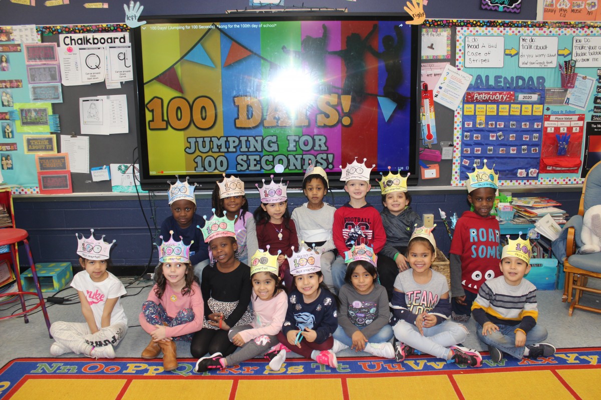 Students pose for a photo wearing costumes of a 100 year old.