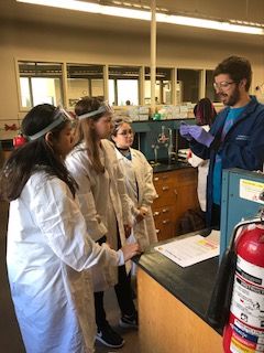Students listen to lab instructor