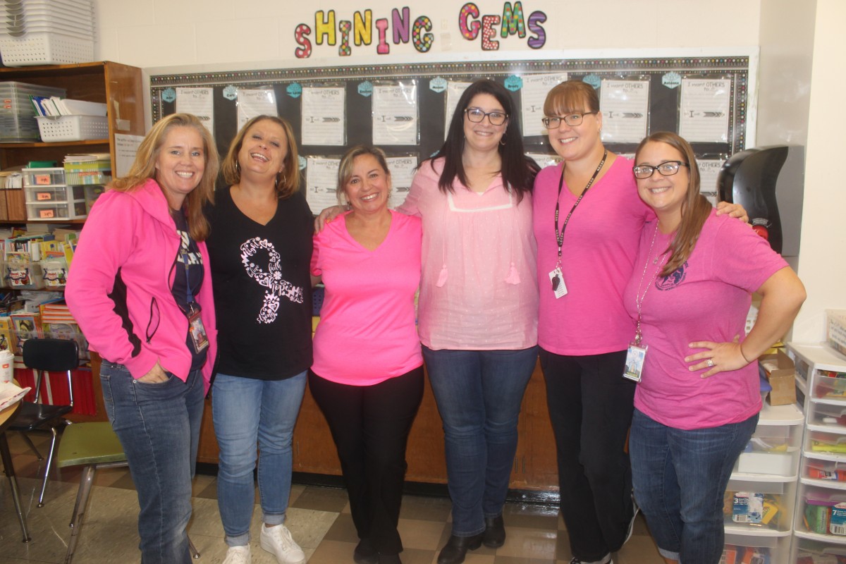 Participants pose for photo in pink.