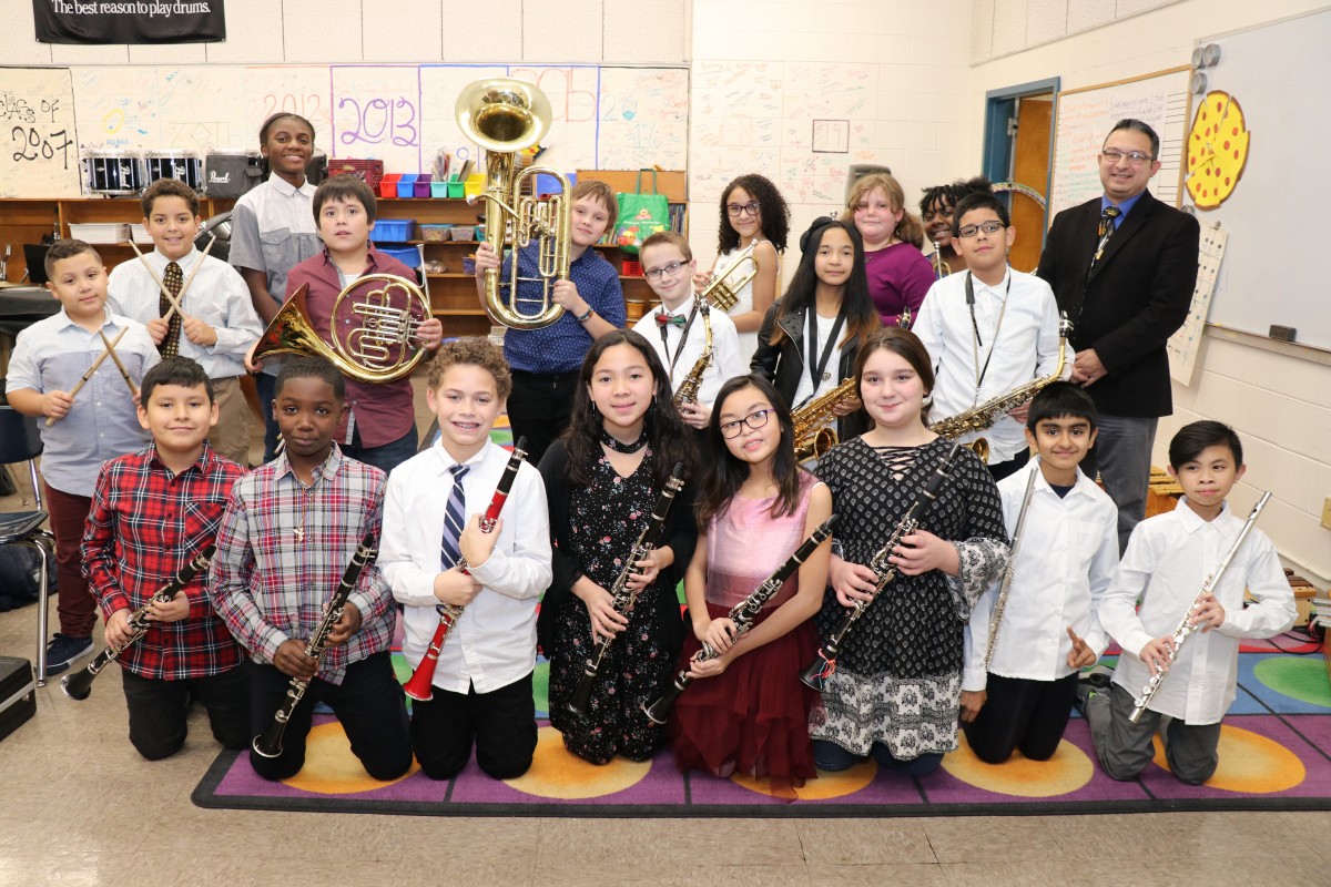 Students pose for a photo with their instruments.