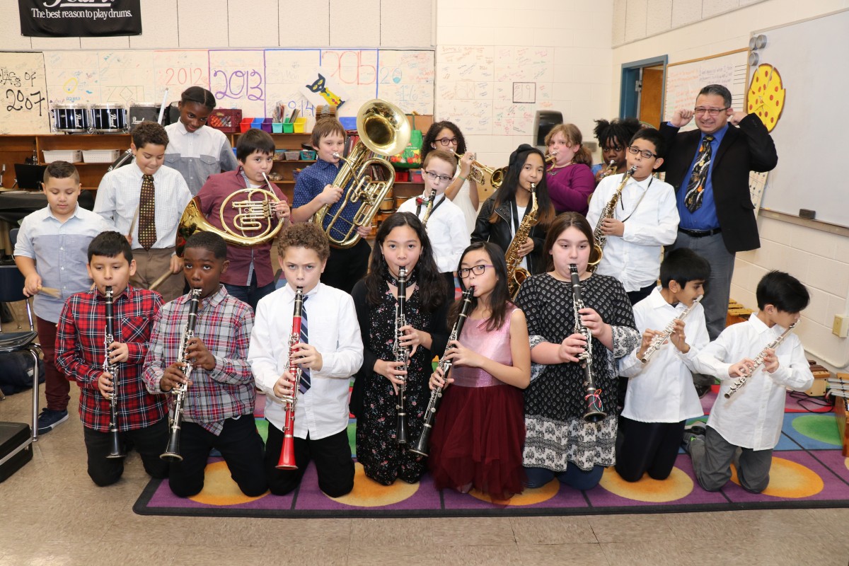 Students pose for a photo with their instruments.