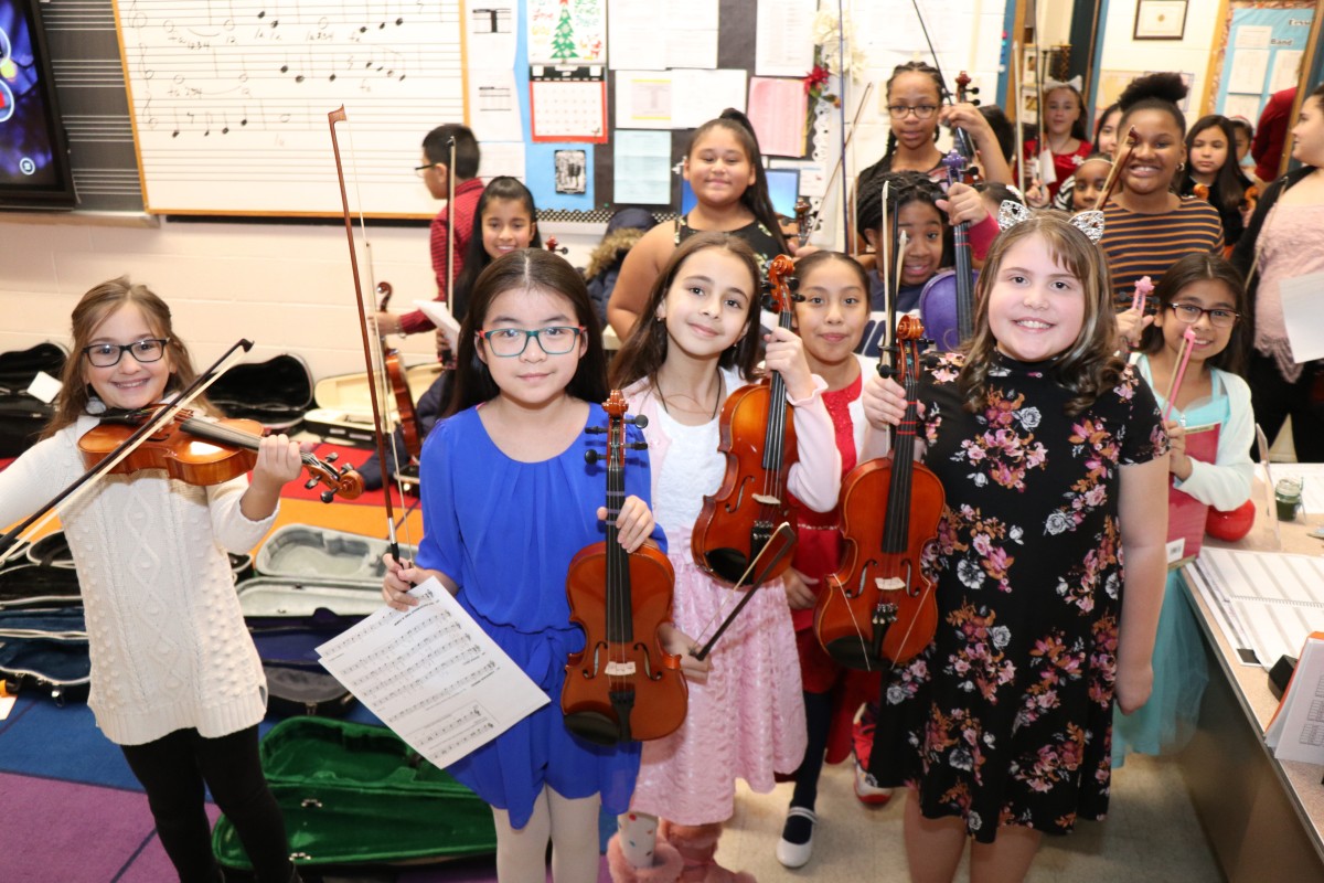 Students pose for a photo with their instruments.