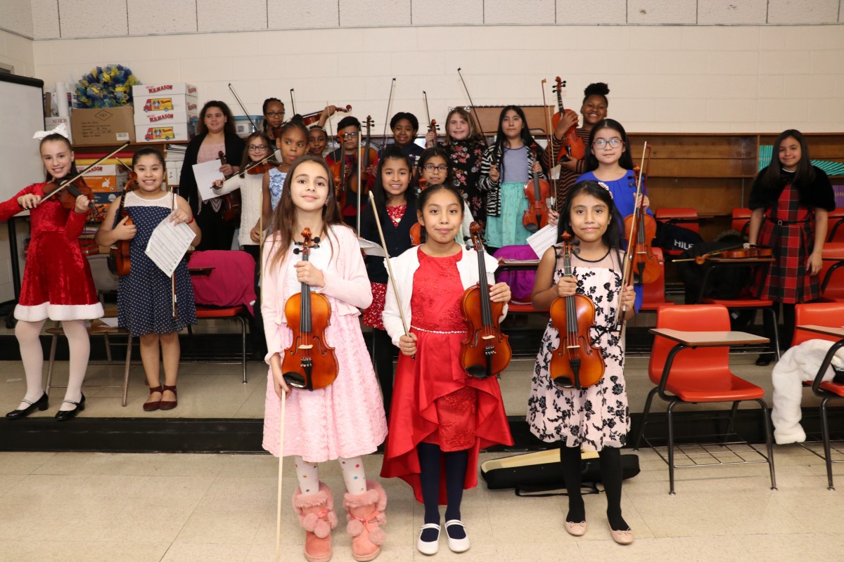 Students pose for a photo with their instruments.