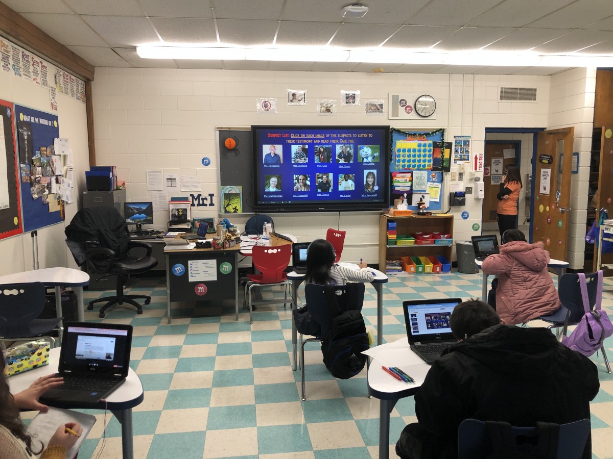 Students viewing Promethean board to follow the lesson.